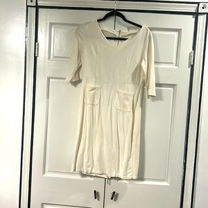 Cream three quarter sleeve dress with front pockets